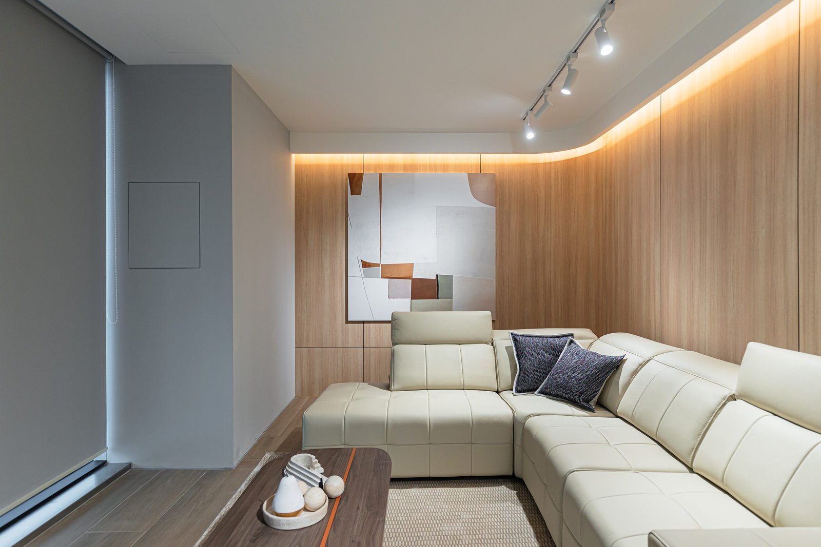 Corner sofa set against curved timber wall panelling