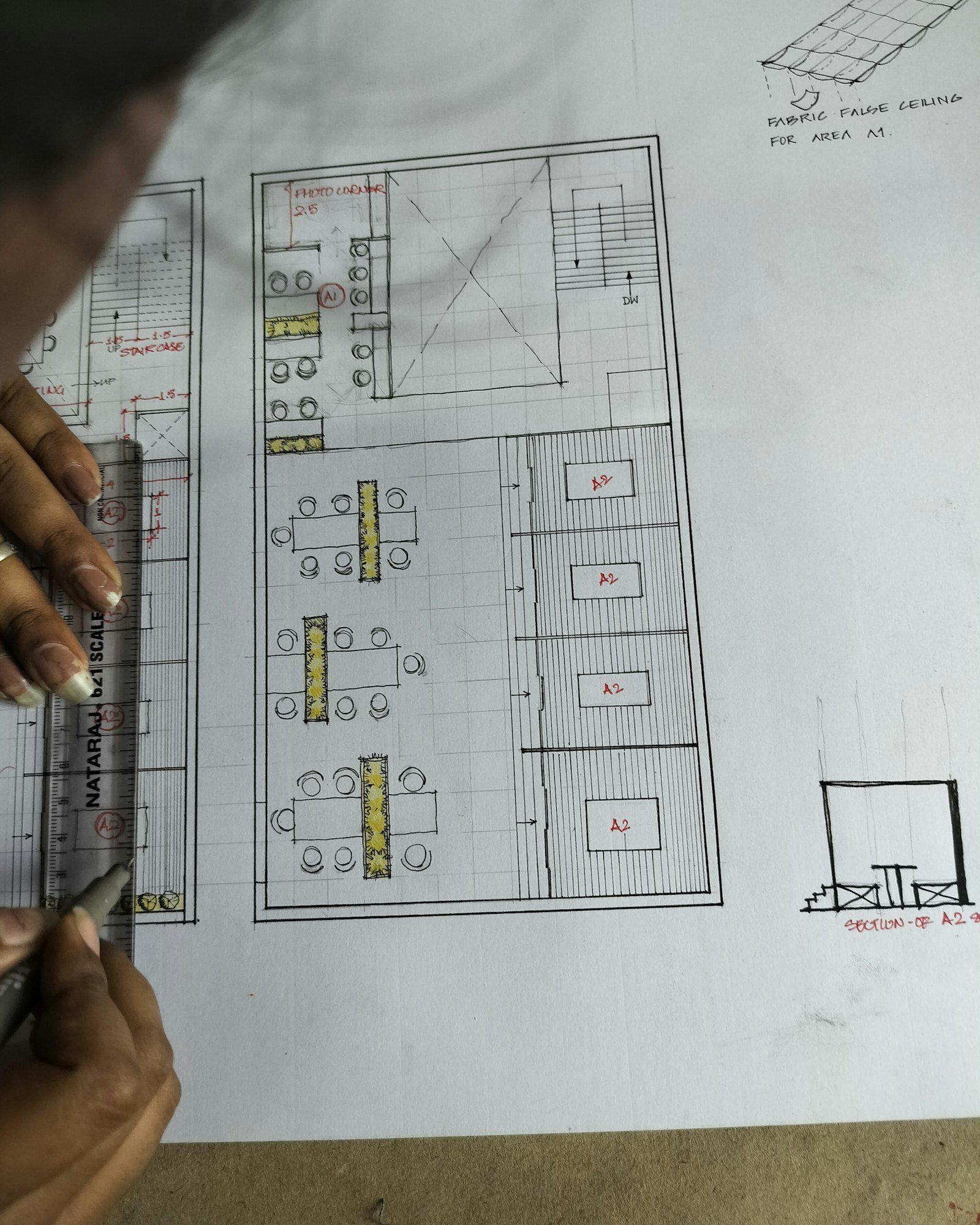 Hand drawing a floor plan layout with a ruler